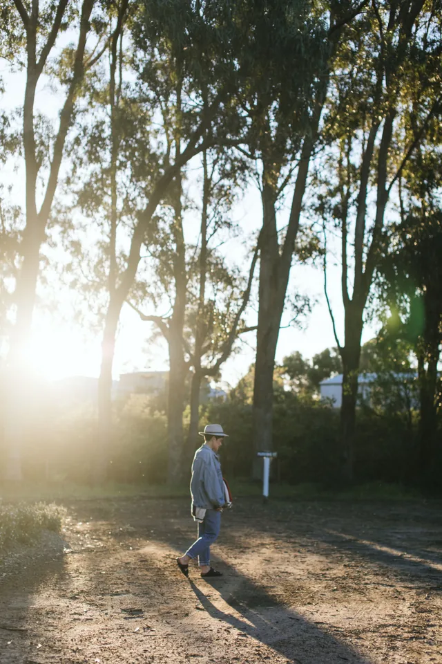 Person taking a leisure walk through a sunlit park