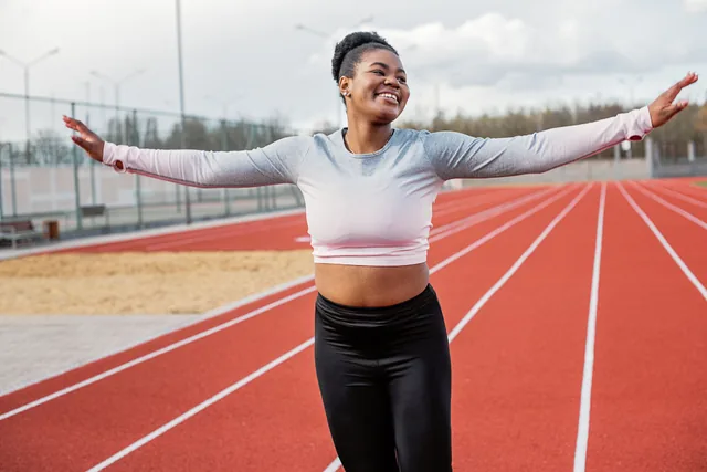 A woman warming up on an outdoor running track